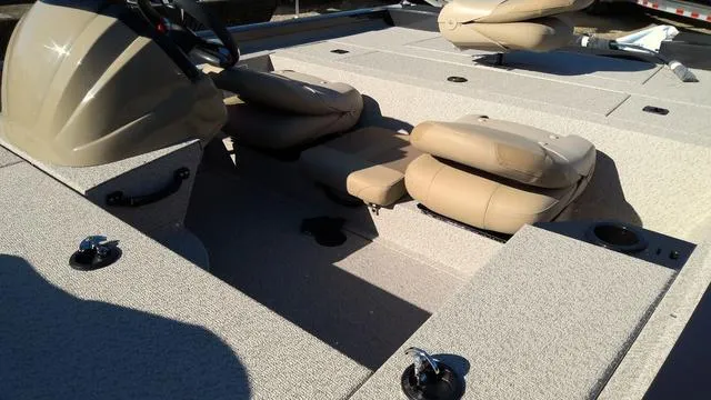 Slide: The Image of 2025 G3 Sportsman 1610 boat interior with beige seating and steering console. - 6