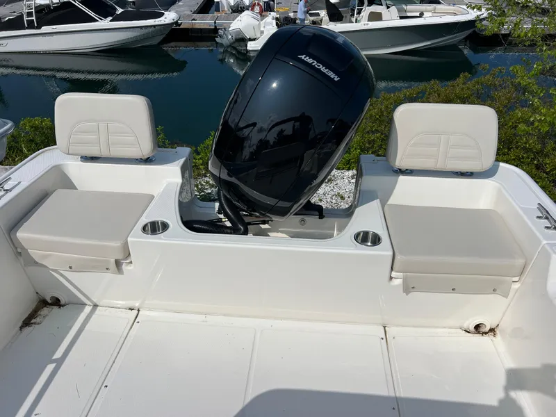 Slide: The Image of 2025 Boston Whaler 170 Montauk boat interior with seating and outboard motor. - 7