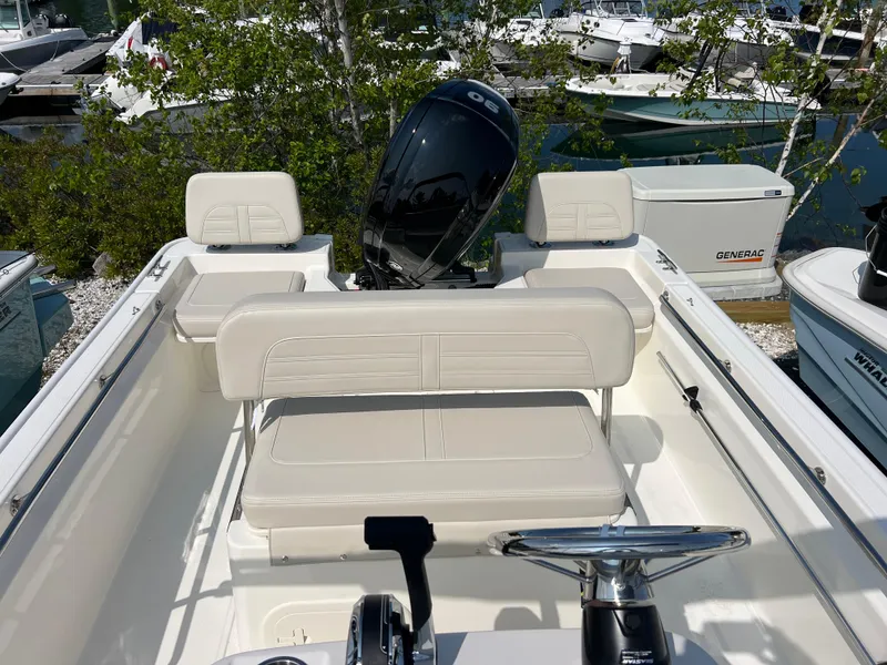Slide: The Image of 2025 Boston Whaler 170 Montauk boat interior with seating and steering wheel. - 8