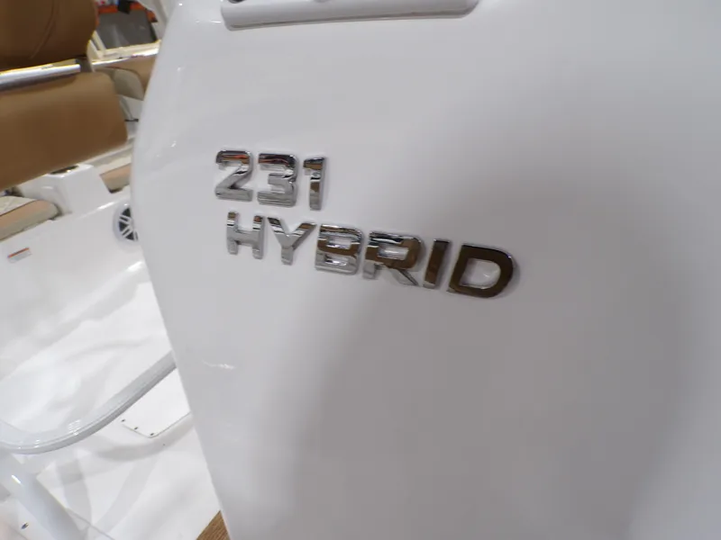 Slide: The Image of 2024 NauticStar 231 Hybrid boat emblem on white surface. - 11
