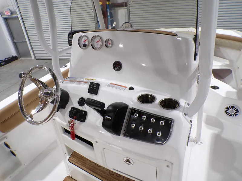 Slide: The Image of 2024 NauticStar 231 Hybrid boat console with steering wheel and control panel. - 13
