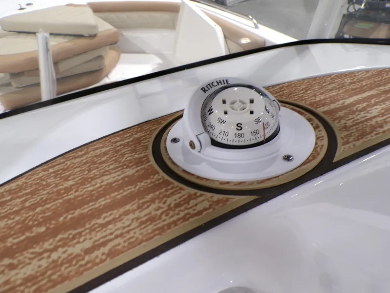 Slide: The Image of 2024 NauticStar 231 Hybrid boat compass on wooden dashboard. - 14