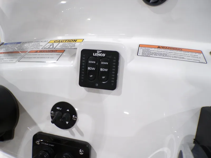 Slide: The Image of Control panel on 2024 NauticStar 231 Hybrid boat with Lenco trim tab switches. - 15