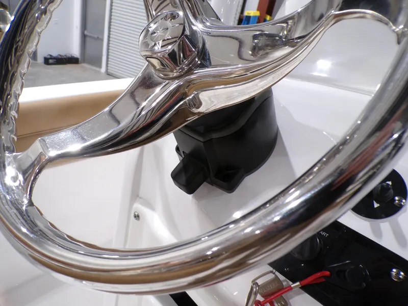 Slide: The Image of Steering wheel of 2024 NauticStar 231 Hybrid boat, shiny chrome finish. - 18