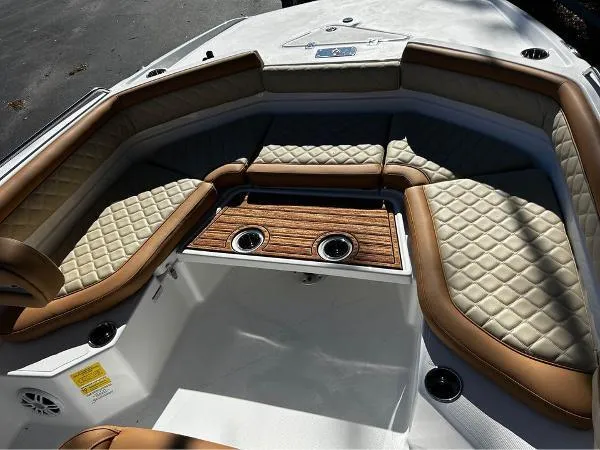 Slide: The Image of 2024 NauticStar 231 Hybrid boat interior with quilted seating and wooden table. - 22