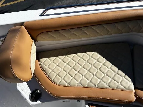 Slide: The Image of 2024 NauticStar 231 Hybrid boat seat with tan and cream quilted upholstery. - 24