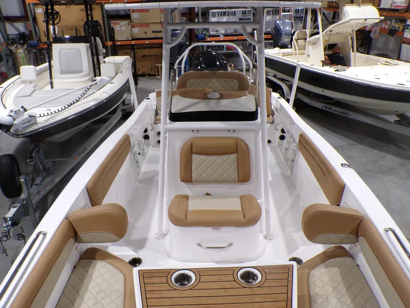 Slide: The Image of 2024 NauticStar 231 Hybrid boat interior with tan seating and wood accents. - 26
