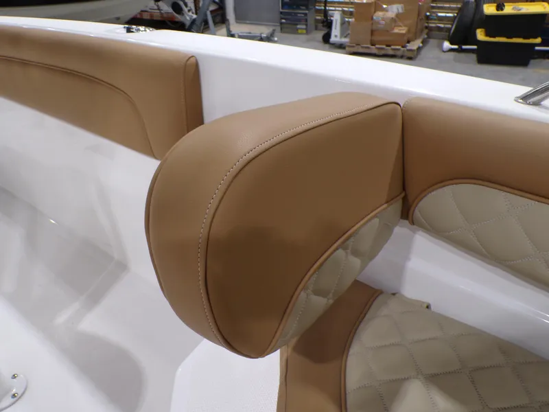 Slide: The Image of 2024 NauticStar 231 Hybrid boat interior with tan cushioned seating. - 27