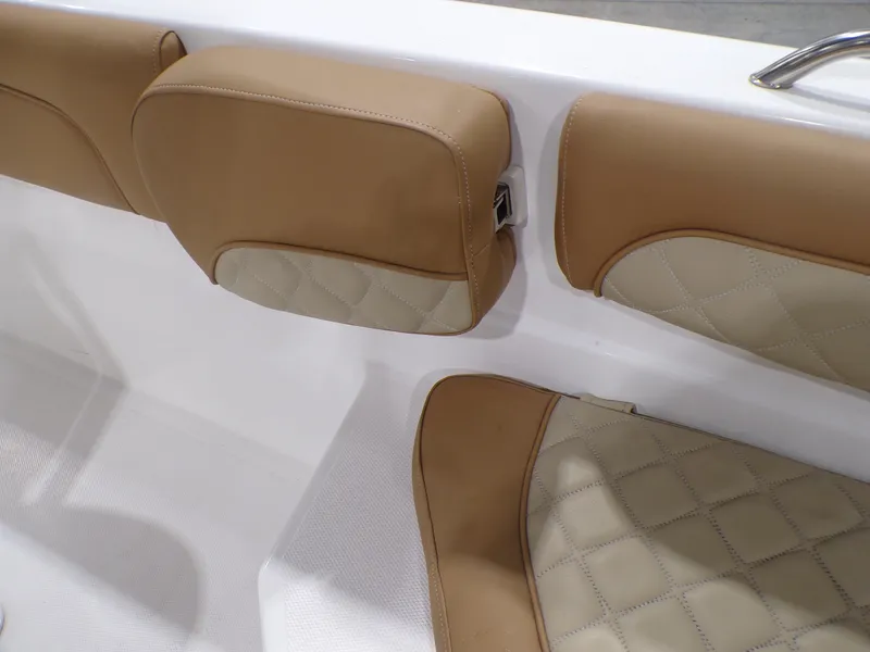 Slide: The Image of 2024 NauticStar 231 Hybrid boat interior with tan and cream cushioned seating. - 28