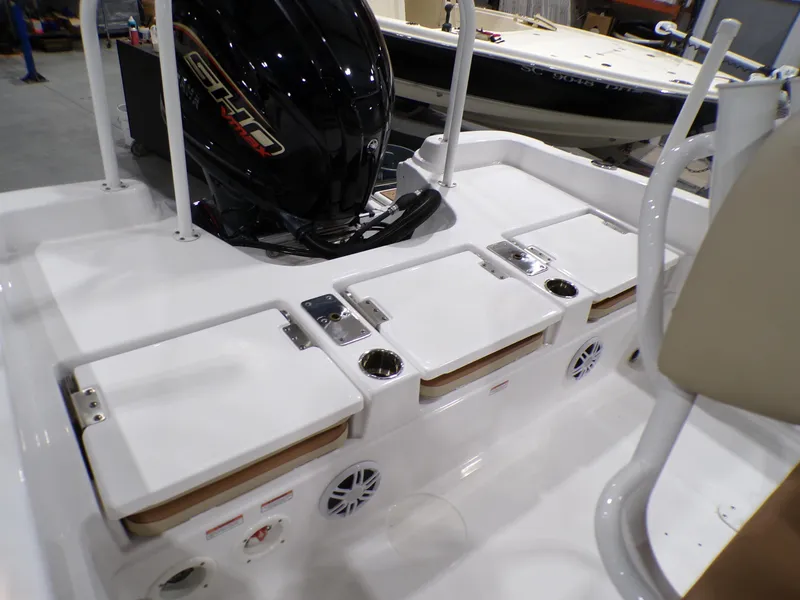 Slide: The Image of 2024 NauticStar 231 Hybrid boat interior with seating and motor. - 29