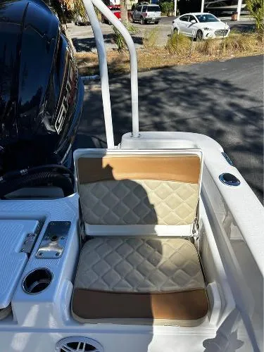 Slide: The Image of 2024 NauticStar 231 Hybrid boat seat with quilted upholstery and cup holder. - 31