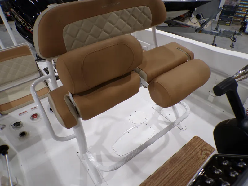 Slide: The Image of 2024 NauticStar 231 Hybrid boat seating with tan upholstery and white frame. - 33