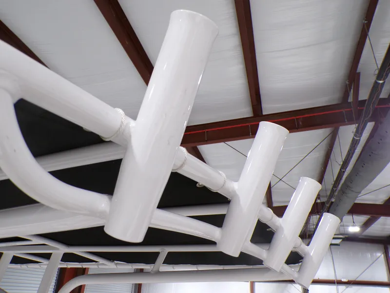 Slide: The Image of 2024 NauticStar 231 Hybrid boat rod holders in a warehouse setting. - 34