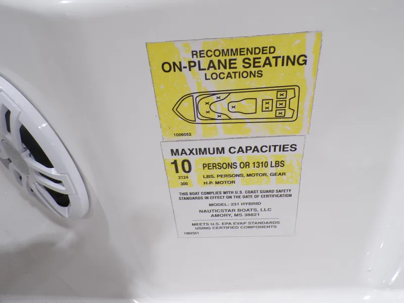 Slide: The Image of 2024 NauticStar 231 Hybrid capacity label, seating diagram, and weight limit details. - 37
