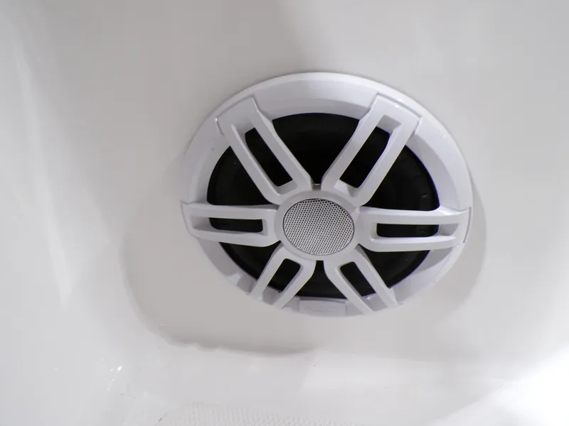 Slide: The Image of 2024 NauticStar 231 Hybrid boat speaker detail, white grille design. - 38