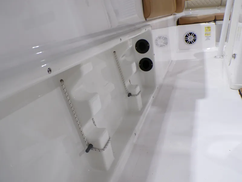 Slide: The Image of 2024 NauticStar 231 Hybrid boat interior with rod holders and speaker. - 40