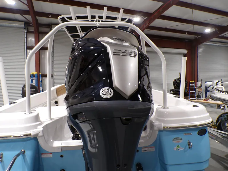 Slide: The Image of 2024 NauticStar 231 Hybrid boat with powerful engine in a showroom. - 5