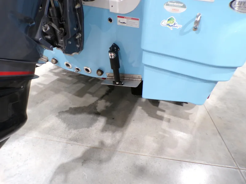 Slide: The Image of 2024 NauticStar 231 Hybrid boat stern with blue hull and motor details. - 6