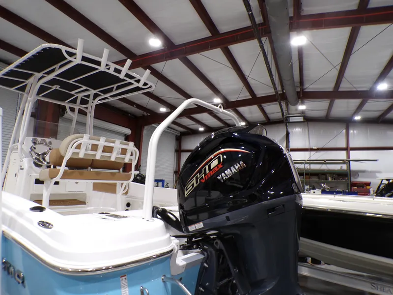 Slide: The Image of 2024 NauticStar 231 Hybrid boat with Yamaha engine in a warehouse. - 8