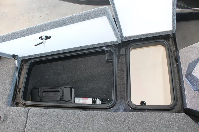 Slide: The Image of Open storage compartments in a 2020 Ranger Z185 boat, featuring carpeted interiors. - 12
