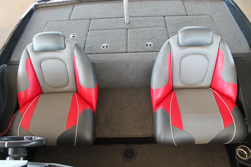 Slide: The Image of 2020 Ranger Z185 boat interior with red and gray seats, carpeted deck. - 14