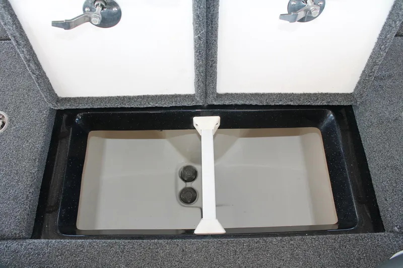 Slide: The Image of 2020 Ranger Z185 boat storage compartment with open hatch and carpeted interior. - 15