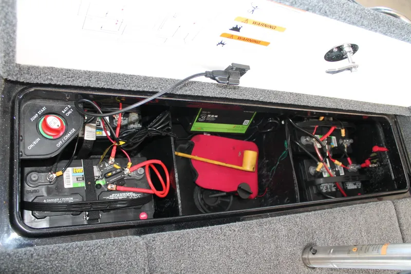 Slide: The Image of 2020 Ranger Z185 boat battery compartment with wiring and safety labels. - 16