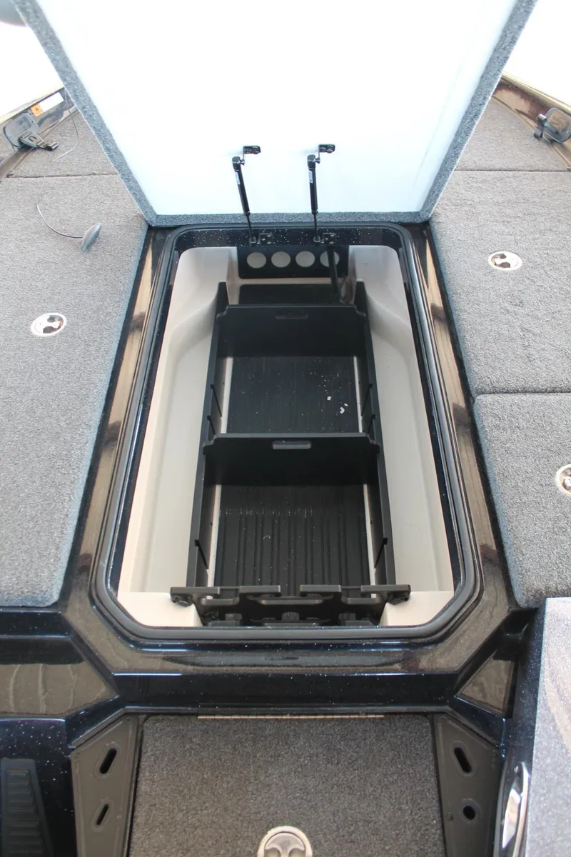 Slide: The Image of 2020 Ranger Z185 boat storage compartment with open lid and organized interior. - 26