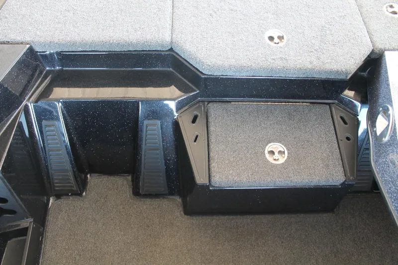 Slide: The Image of 2020 Ranger Z185 boat deck with carpeted storage compartments and sleek black finish. - 28