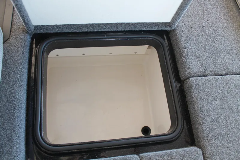 Slide: The Image of 2020 Ranger Z185 boat storage compartment with gray carpeted interior. - 30
