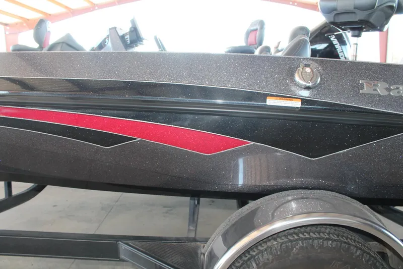 Slide: The Image of 2020 Ranger Z185 boat with sleek black and red design, parked indoors. - 5
