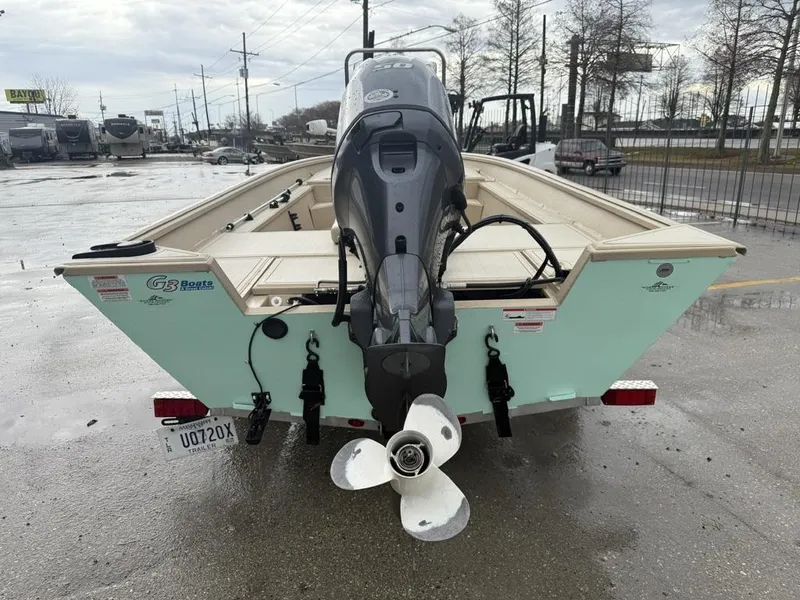 Slide: The Image of 2021 G3 17 BAY boat with outboard motor on a trailer in a parking lot. - 10