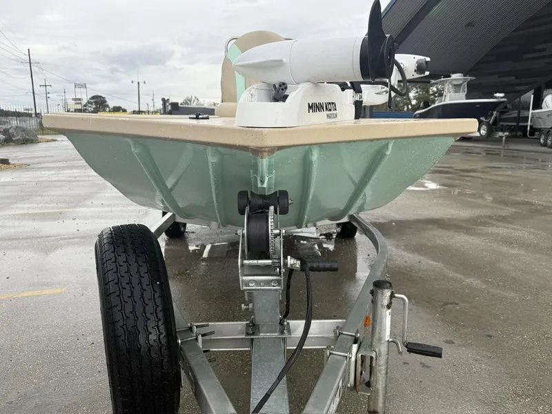 Slide: The Image of 2021 G3 17 BAY boat on trailer with Minn Kota motor, parked outdoors. - 11