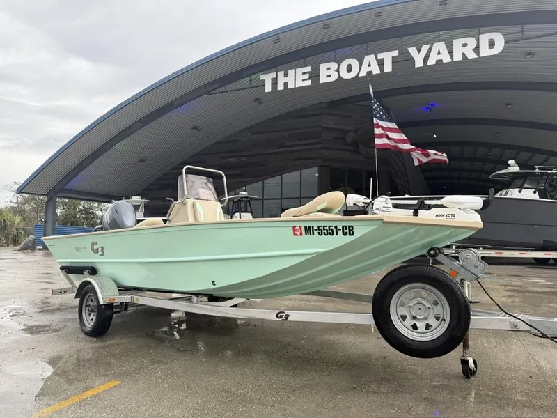 Slide: The Image of 2021 G3 17 BAY boat on trailer at The Boat Yard, American flag visible. - 12