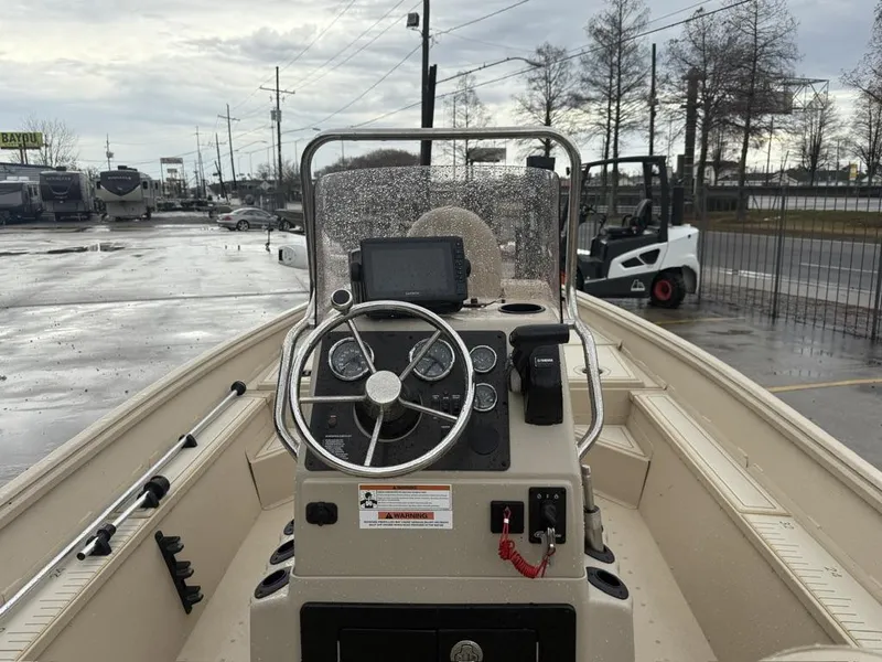 Slide: The Image of 2021 G3 17 BAY boat dashboard with steering wheel and controls, parked outdoors. - 14