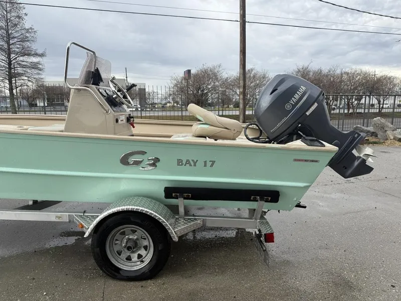 Slide: The Image of 2021 G3 17 BAY boat with Yamaha motor on trailer, parked outdoors. - 16