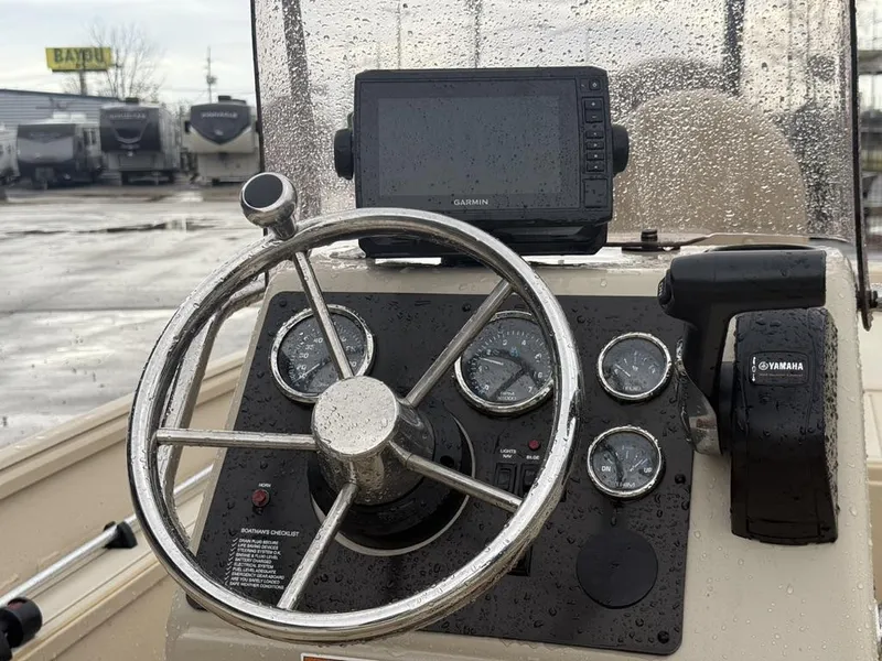 Slide: The Image of Boat dashboard with steering wheel, Garmin GPS, and Yamaha controls, G3 17 BAY 2021 model. - 17