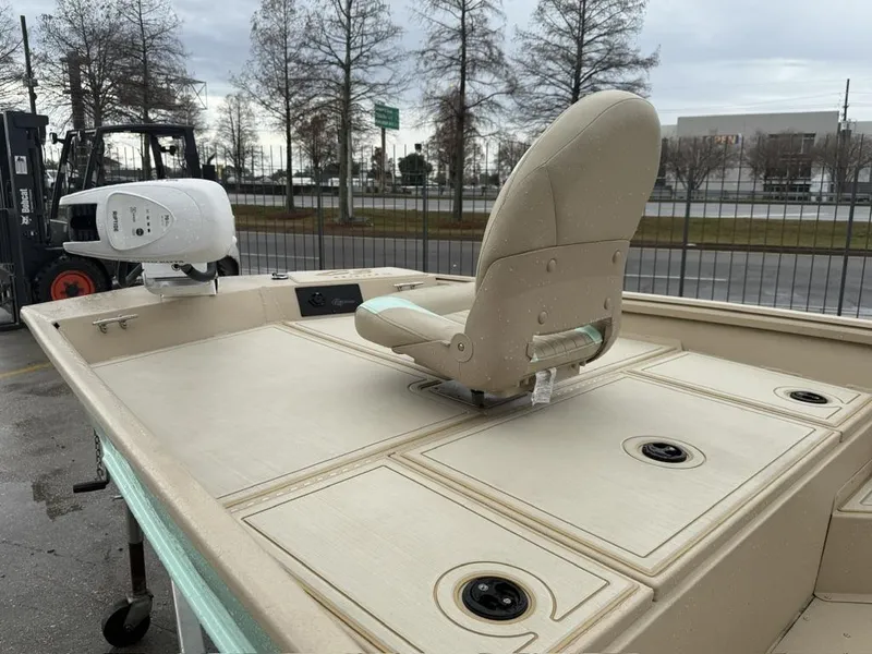 Slide: The Image of 2021 G3 17 BAY boat with beige seating and deck, parked outdoors. - 3