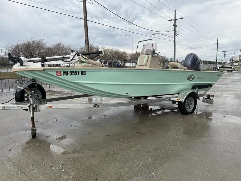 Slide: The Image of 2021 G3 17 BAY boat on trailer, light green, parked outdoors. - 6
