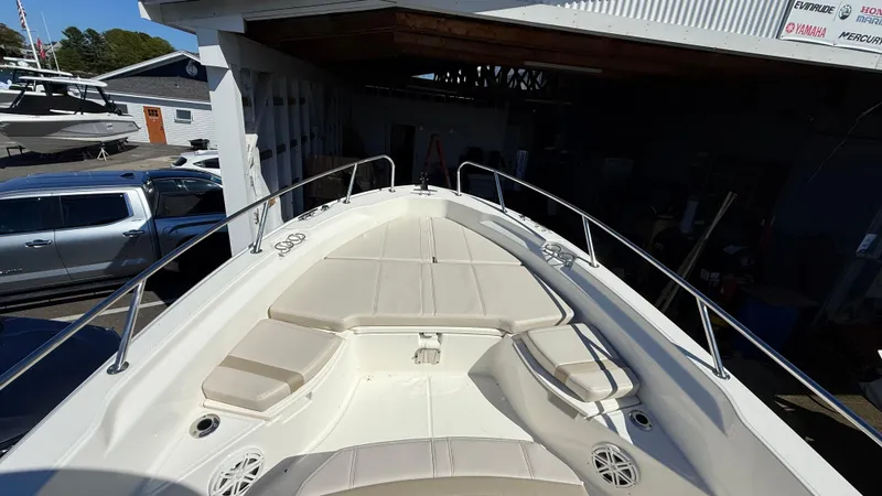 Slide: The Image of 2025 Boston Whaler 250 Dauntless boat deck with cushioned seating and railings. - 2