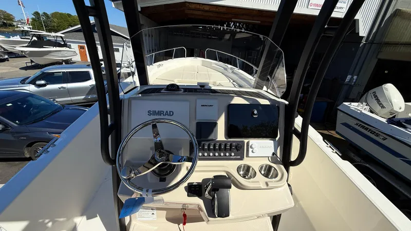 Slide: The Image of 2025 Boston Whaler 250 Dauntless boat console with steering wheel and navigation equipment. - 4