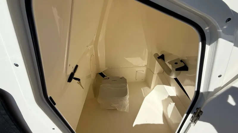 Slide: The Image of Interior of 2025 Boston Whaler 250 Dauntless boat, featuring a compact storage compartment. - 8