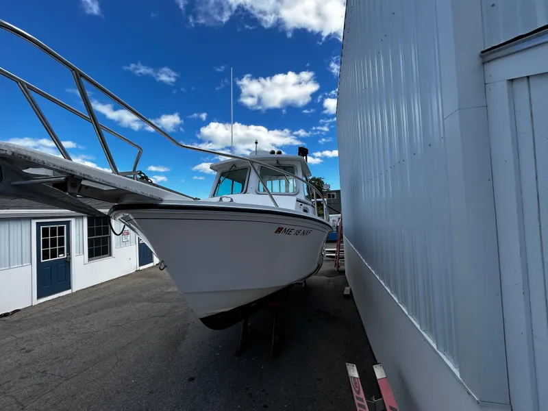 Slide: The Image of 2014 Steiger Craft 21 DV MIAMI boat parked beside a building under a blue sky. - 11