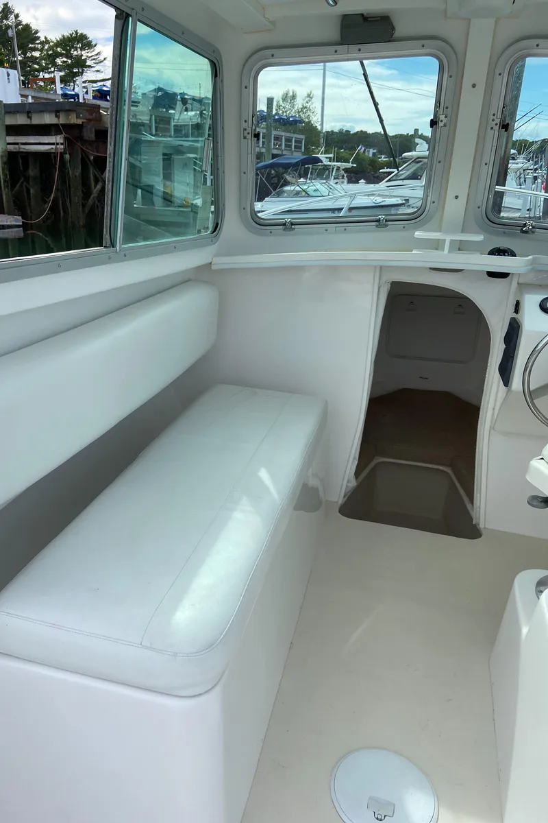 Slide: The Image of 2014 Steiger Craft 21 DV MIAMI boat interior with white seating and windows. - 20