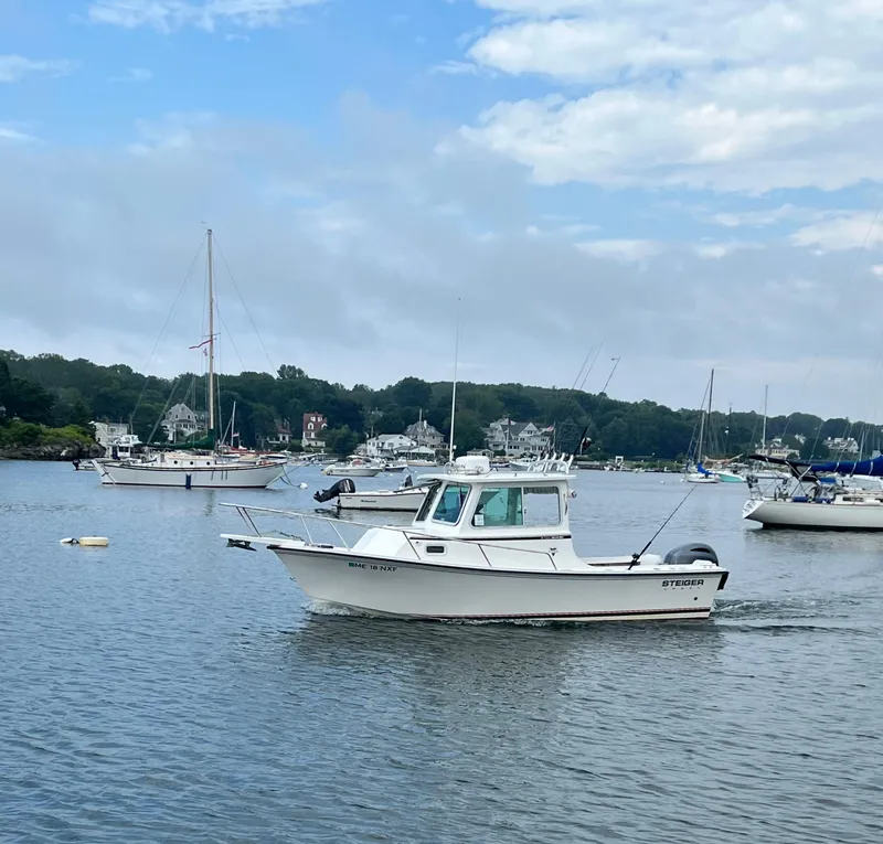 Slide: The Image of 2014 Steiger Craft 21 DV MIAMI boat on calm water with sailboats in the background. - 3