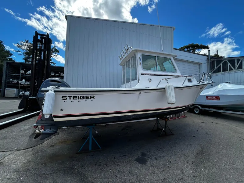Slide: The Image of 2014 Steiger Craft 21 DV MIAMI boat on stands, outdoor storage, clear sky. - 7