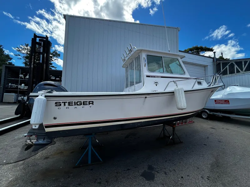 Slide: The Image of 2014 Steiger Craft 21 DV MIAMI boat on stands, white exterior, outdoor setting. - 8