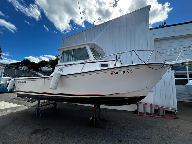 Slide: The Image of 2014 Steiger Craft 21 DV MIAMI boat on display outside, under a blue sky. - 9