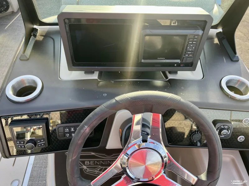 Slide: The Image of Dashboard of 2025 Bennington M22 boat with steering wheel and navigation display. - 11
