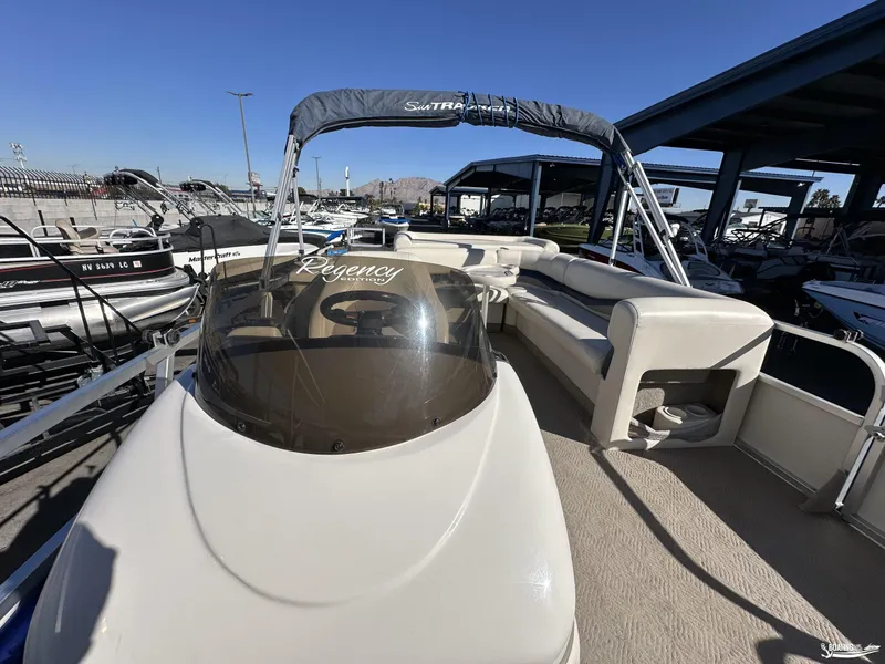 Slide: The Image of 2005 Sun Tracker PARTY BARGE 25 pontoon boat with seating and canopy in a marina. - 13